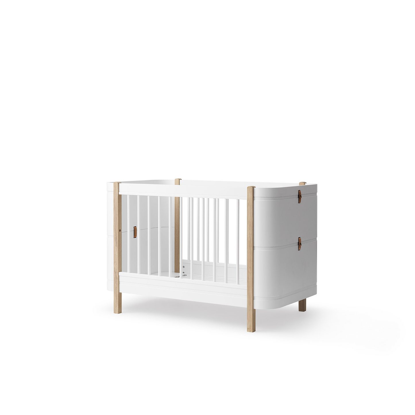 White crib with wooden frame on a white background