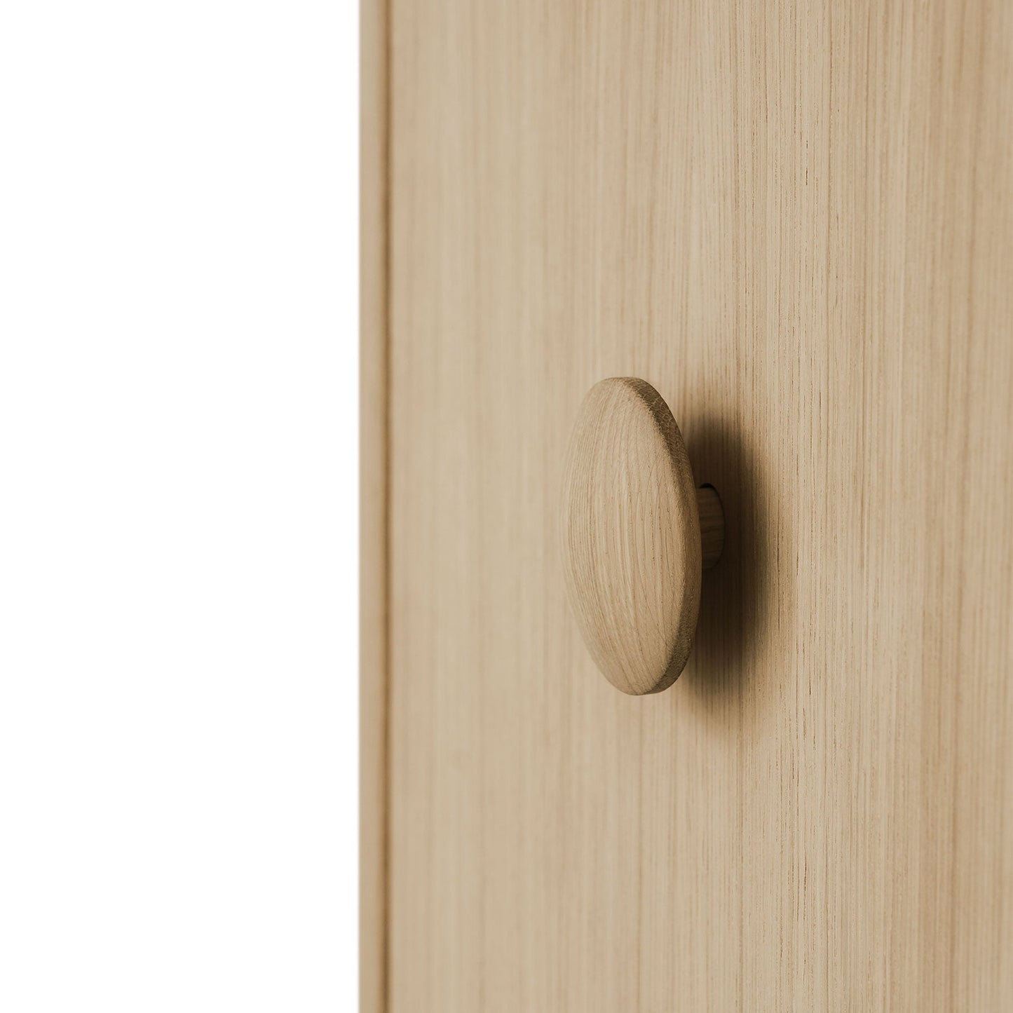 Wooden cabinet door with a round knob on a light wood background