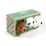 Small plush bear and dog toy peeking out from a green box with a wooden lid.