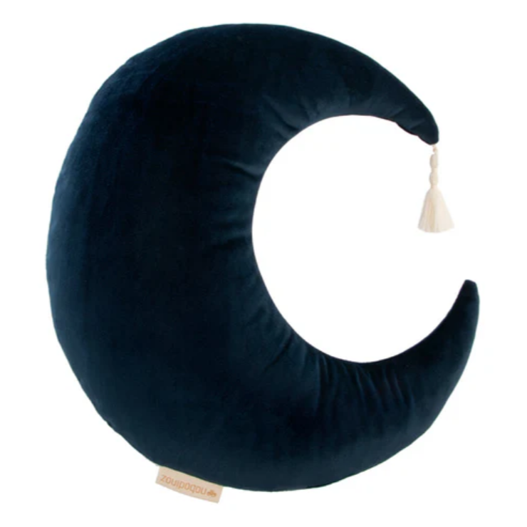 Navy blue crescent moon-shaped pillow with a tassel on a white background
