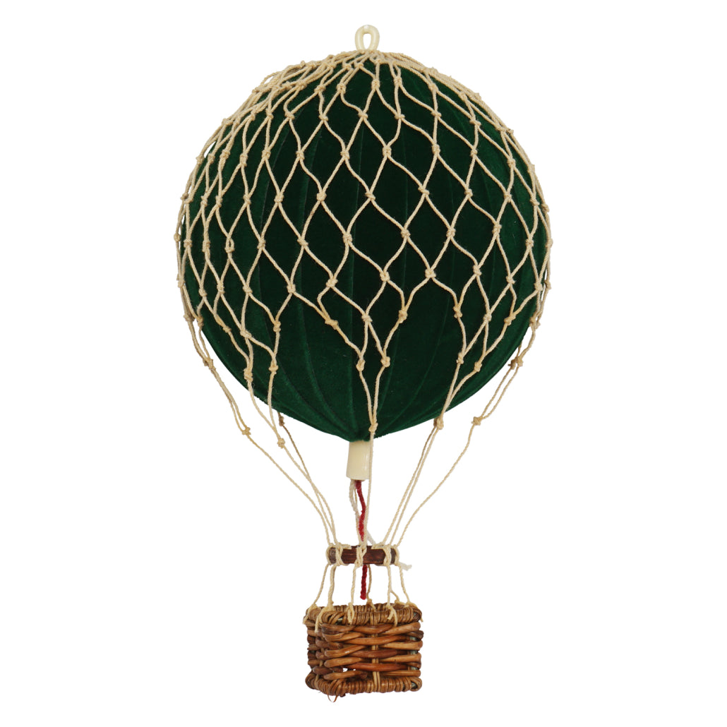 Decorative hot air balloon with green envelope and wicker basket on a white background