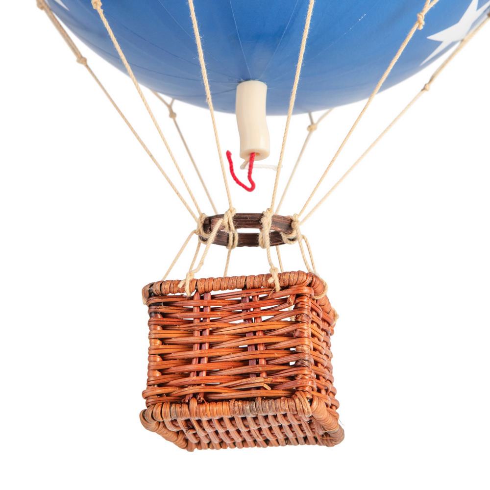 Hot air balloon with blue envelope and wicker basket on a white background