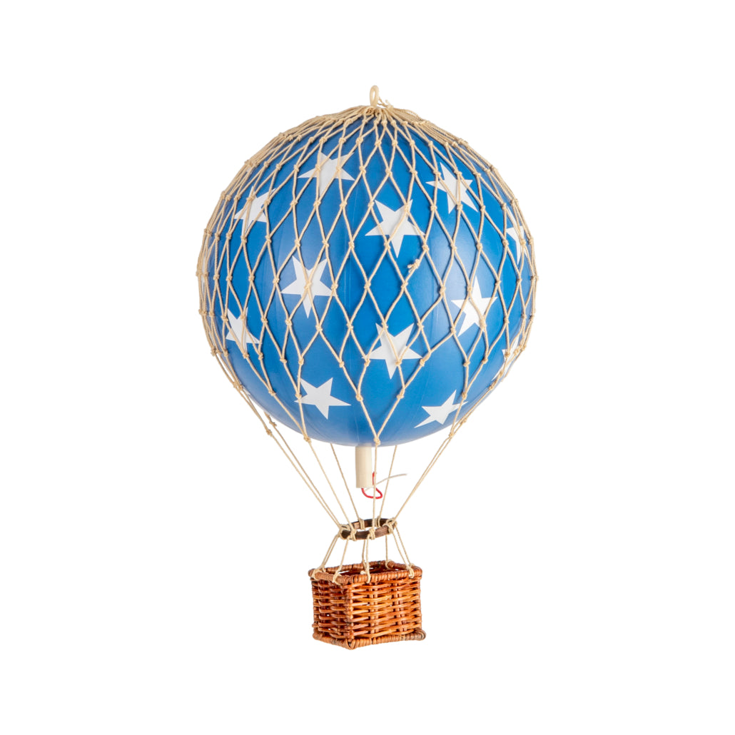 Blue hot air balloon with star pattern and wicker basket on a white background