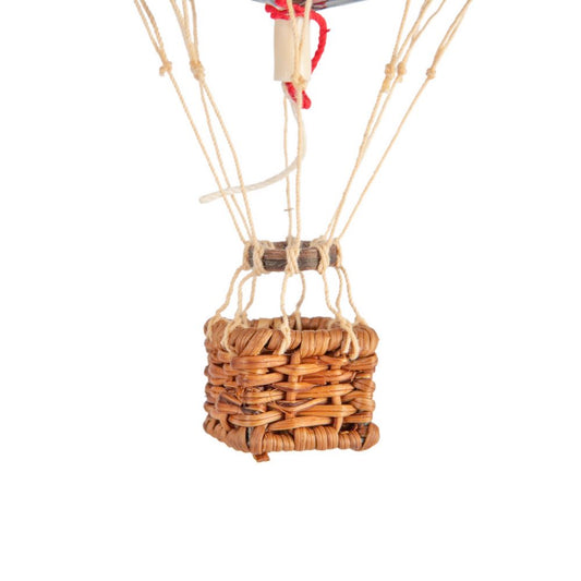 Wicker hot air balloon basket with strings on a white background