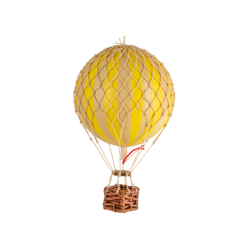Model hot air balloon with yellow and beige design on a white background
