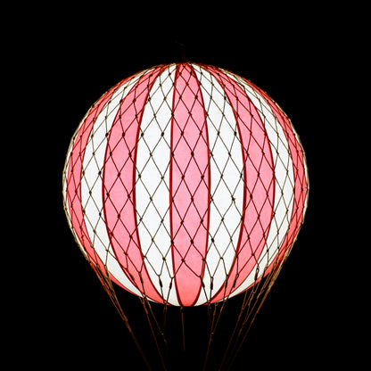 Pink and white striped spherical lantern on a black background