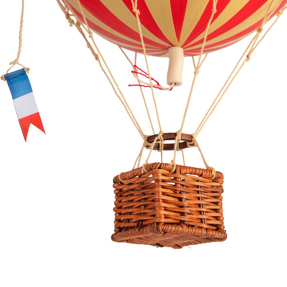 Hot air balloon with a wicker basket and a small flag on a white background