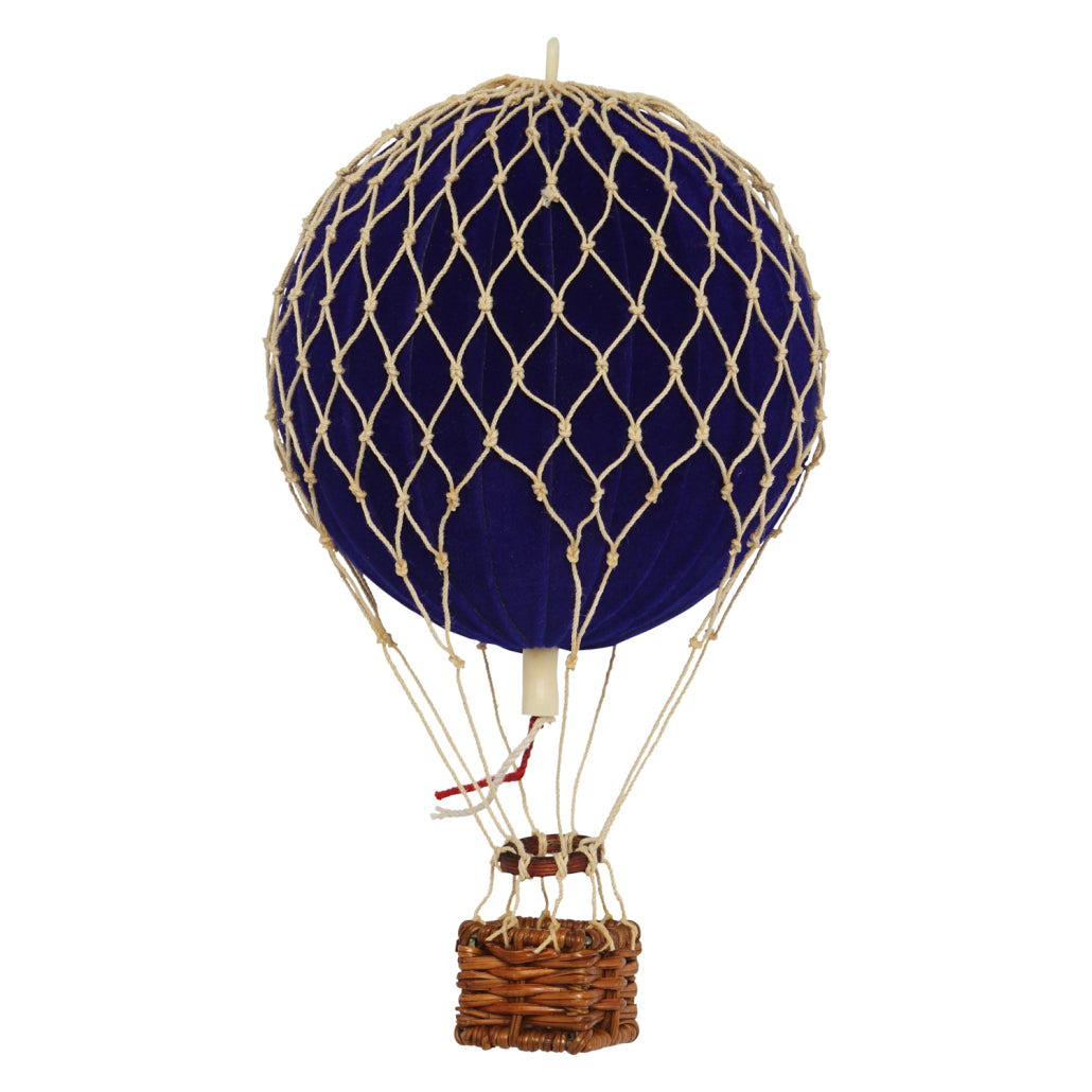 Model hot air balloon with blue balloon and wicker basket on a white background