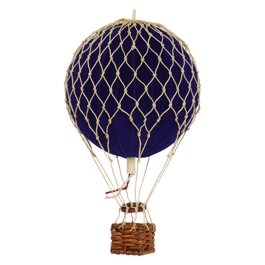 Model hot air balloon with blue balloon and wicker basket on a white background