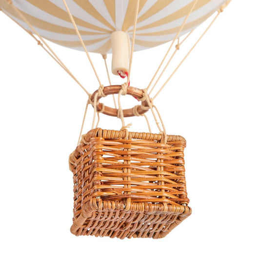 Hot air balloon with wicker basket on a white background