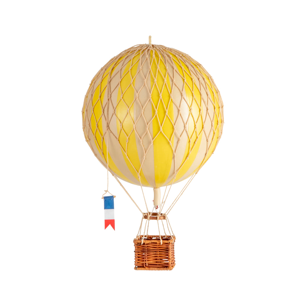 Yellow hot air balloon with a wicker basket on a white background