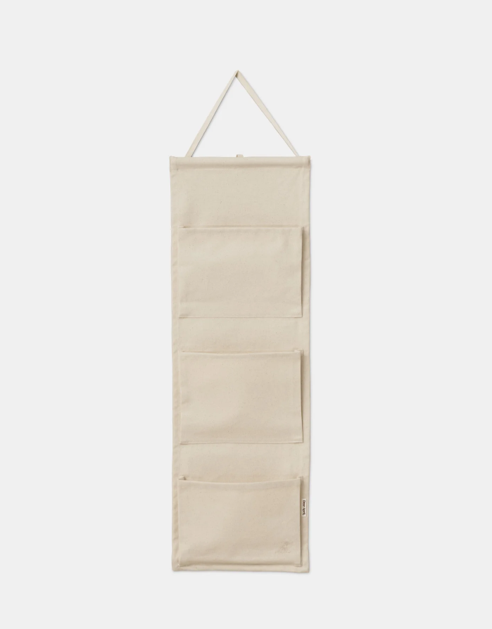 Beige hanging organizer with multiple compartments on a white background