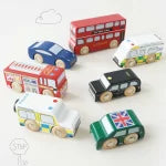 Set of miniature model cars with British-themed designs on a white background