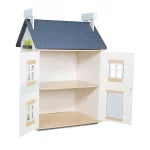 Wooden dollhouse with a blue roof on a white background