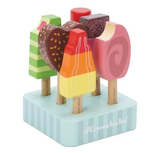 Wooden ice cream toy set on a blue base with 'Hevea' branding.