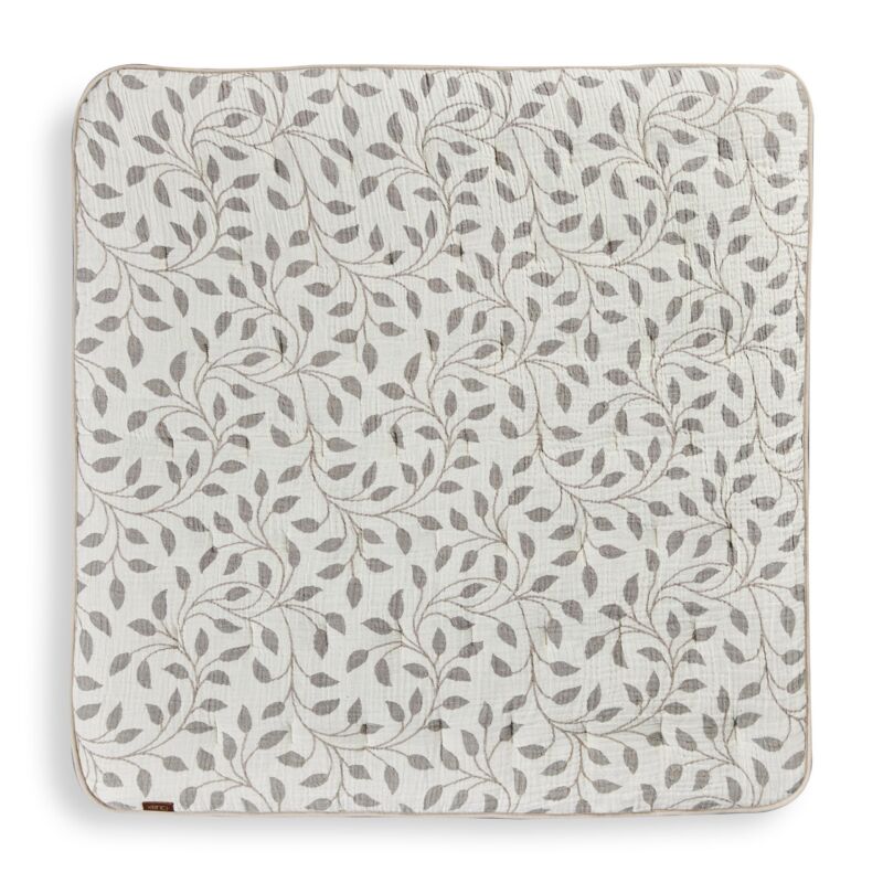 Patterned play mat with leaf design on a white background