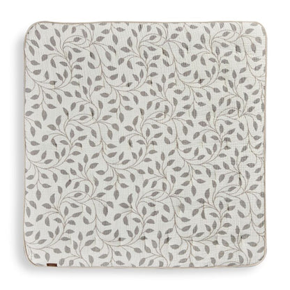 Patterned play mat with leaf design on a white background