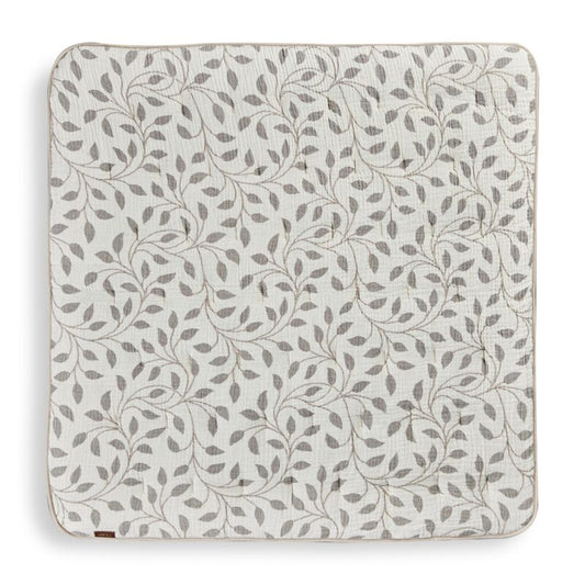 Patterned play mat with leaf design on a white background