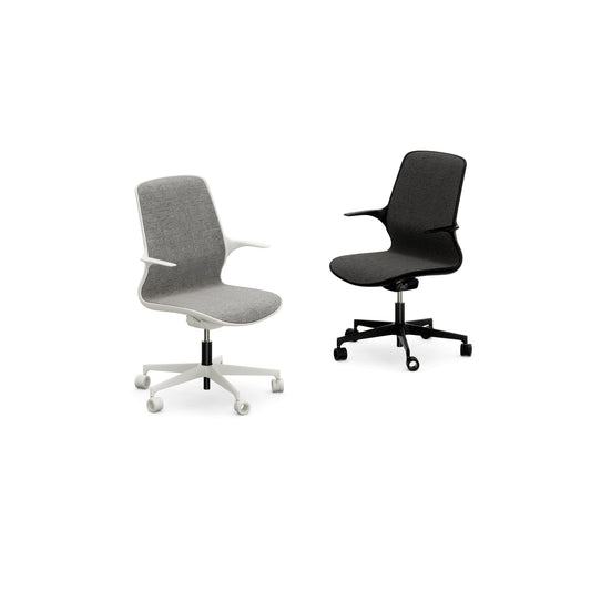 Two Nidi Leaf children’s ergonomic desk chairs with upholstered seats and armrests, one in white and one in black