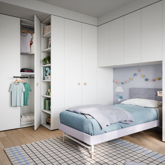 Modern bedroom with white walls, a bed, and wardrobe.