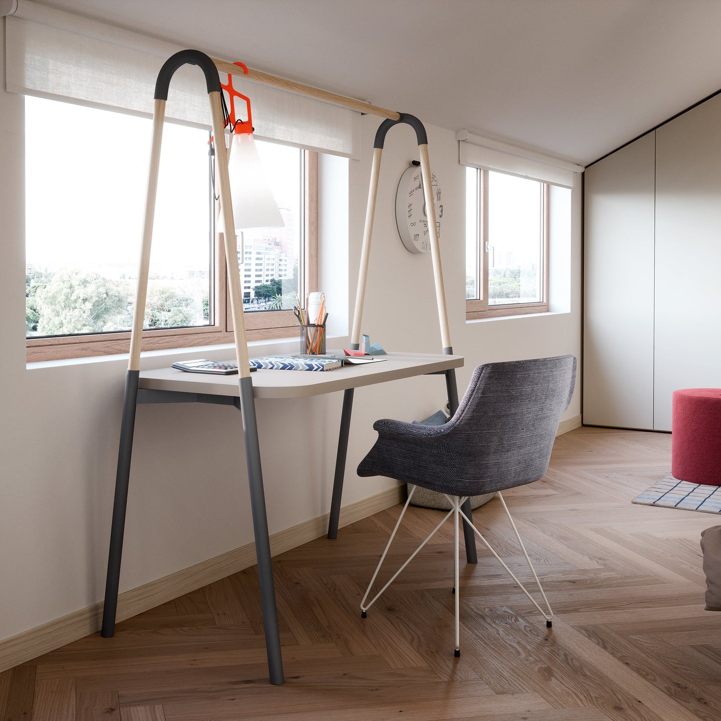 A modern minimalist bedroom featuring a unique desk with integrated ladder-style side supports, a gray woven chair, herringbone wood flooring, and a bed with beige bedding.