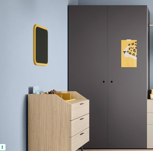 Gray wardrobe with a wooden dresser and decorative items in a room.