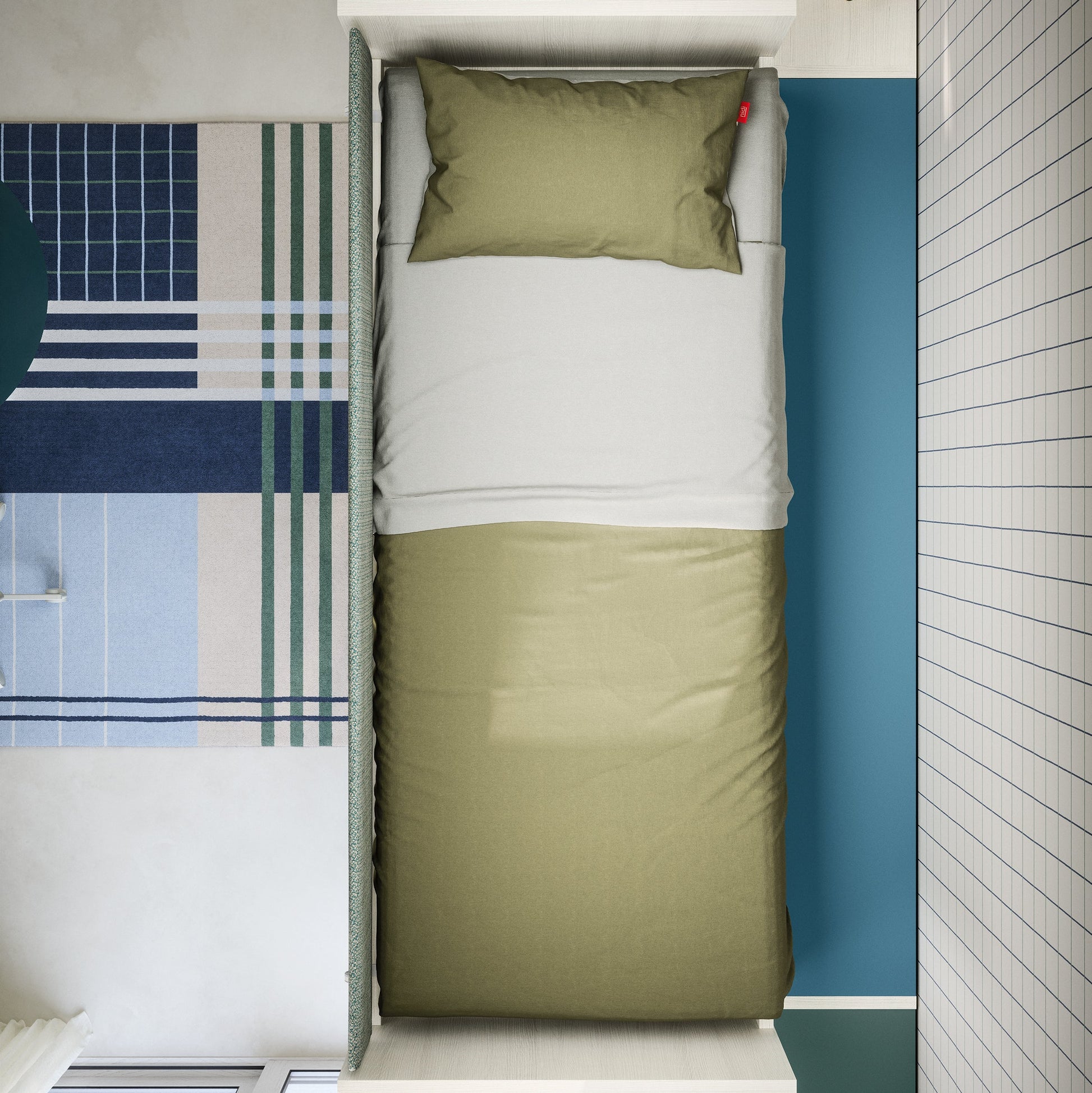 Top-view of Nidi Kids Space 12 bed with green duvet, blue wall panel and graphic patterned rug.