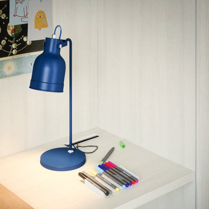 Close-up of Nidi Kids Space 12 desk with blue lamp, stationery and pale wood finish.