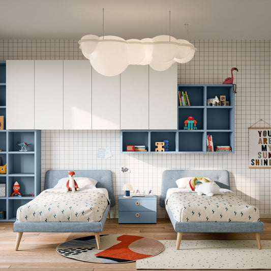 Twin Nidi kids bedroom with modular wall shelving, two upholstered beds, and playful modern decor