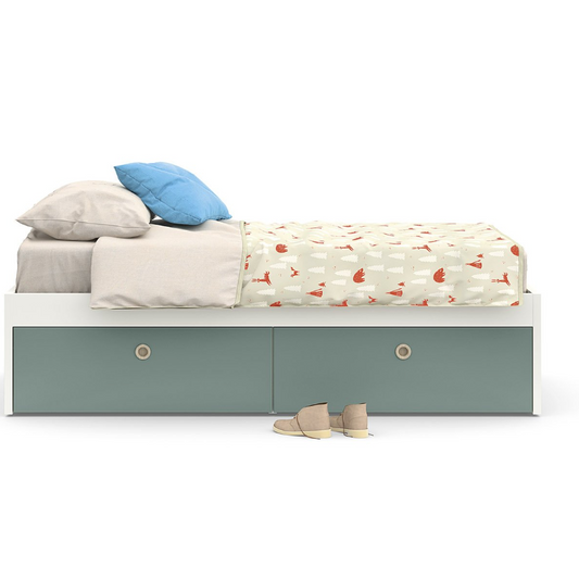 White bed with gray drawers and colorful bedding on a white background