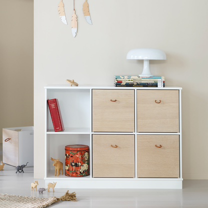 White shelf with wooden drawers and decorative items against a plain wall.