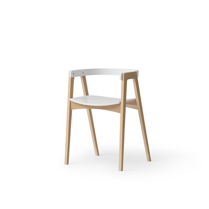 Modern chair with white seat and backrest on a light wood frame against a white background