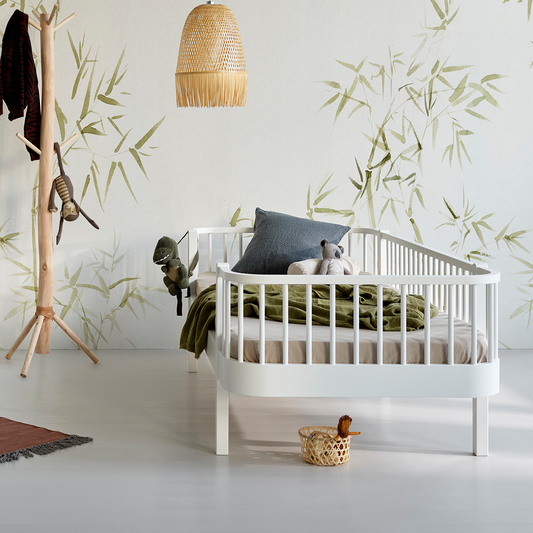 White Kids Day bed, bamboo-themed wallpaper, and wooden coat rack.