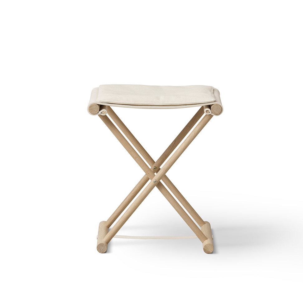 A compact folding stool with a light beige fabric seat and a natural wood X-frame base, shown on a clean white background.