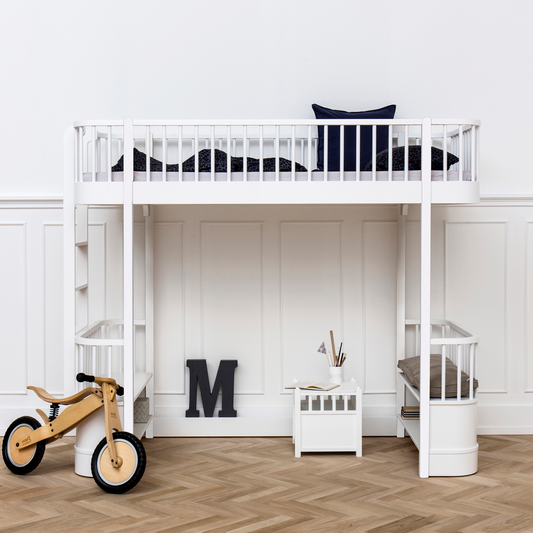 Children's room with a white loft bed, wooden floor, and toys.