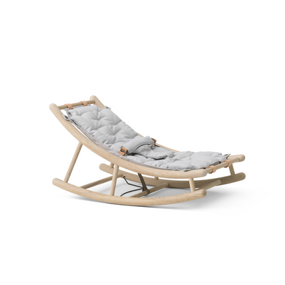 Beige baby rocker with gray cushion on a white background