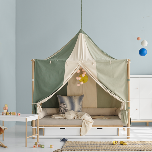 Children's CIRCUS STYLED BED with a canopy bed against a light blue wall.