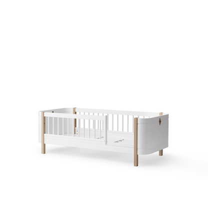 White crib with wooden accents on a white background