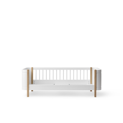 White crib with wooden accents on a white background