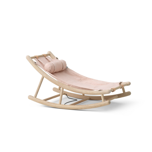 Pink baby swing with beige cushion on a white background