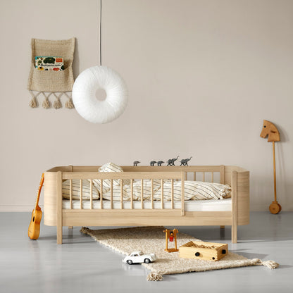 Wooden crib in a nursery with toys and decor