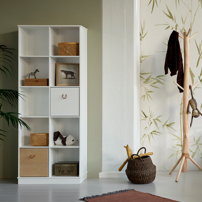 White bookshelf with wooden drawers and shelves in a room with a coat rack and rug.