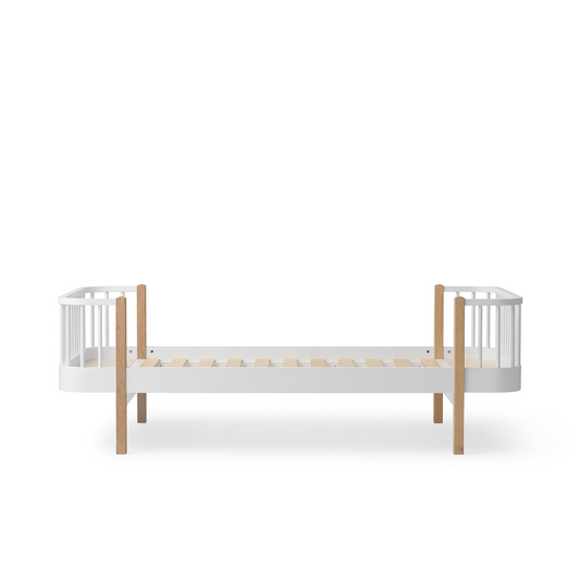 White crib with wooden sides on a white background