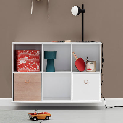 White storage unit with wooden drawer against a brown wall, featuring toys and decorative items.