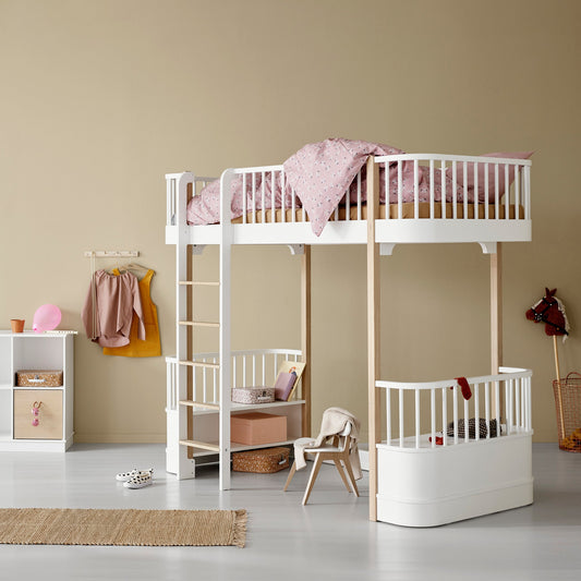 Children's room with a white bunk bed and baby crib against a beige wall.