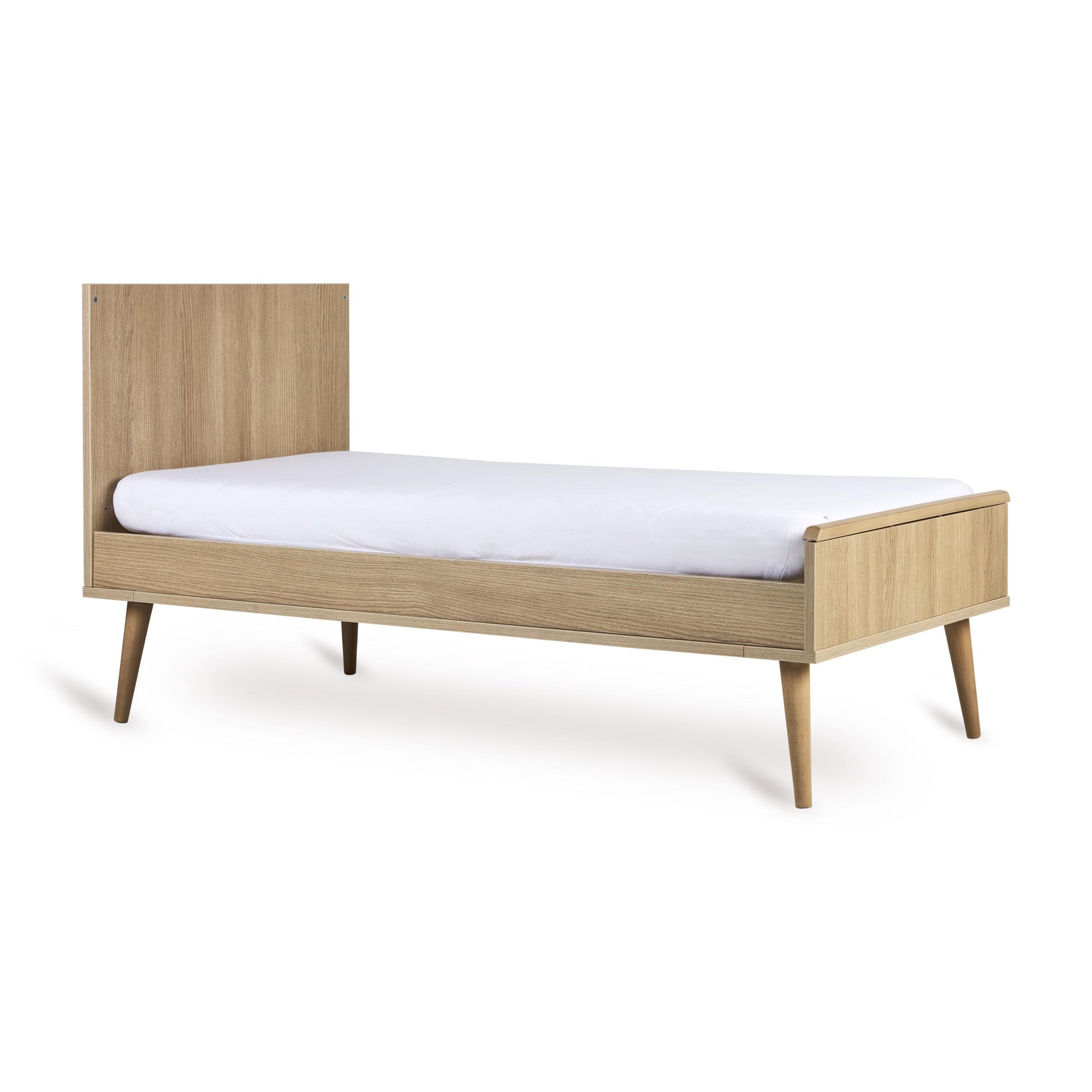 Quax Flow cot bed converted into a toddler bed, honey ash finish