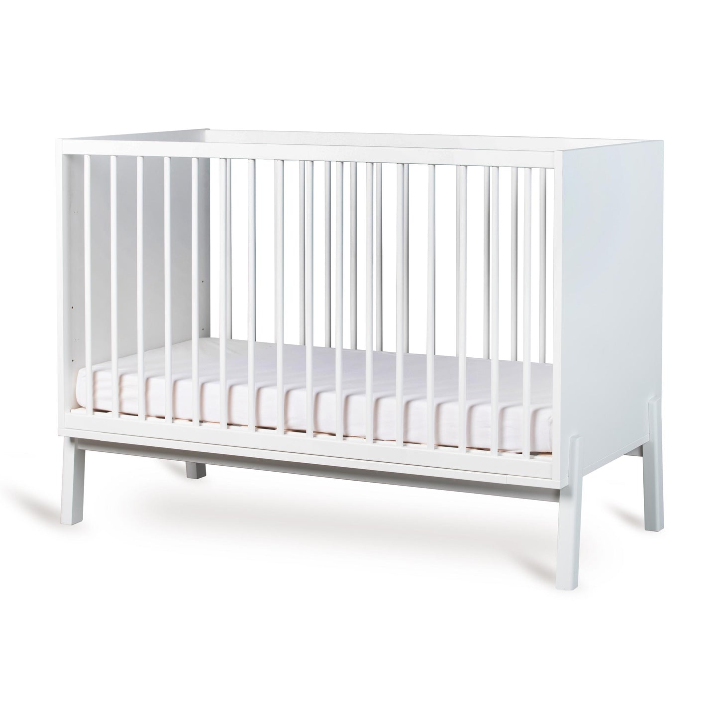 Cream crib with a white mattress on a white background