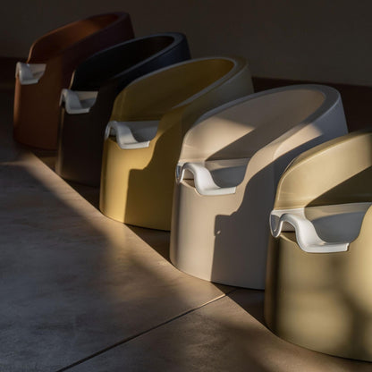 Row of modern stools with different colors on a dark floor.