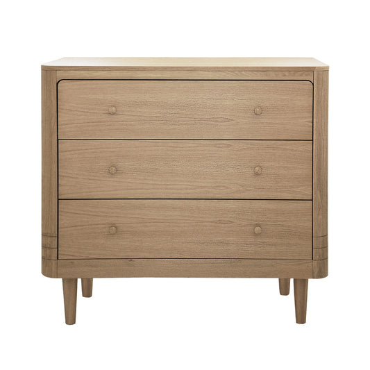 Wooden baby dresser with three drawers on a white background