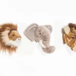 Two plush toys, a lion and an elephant, on a white background.